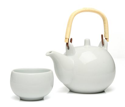 Ceramic teapot and a tea cup over white background