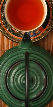 Chinese teapot and tea cup over bamboo