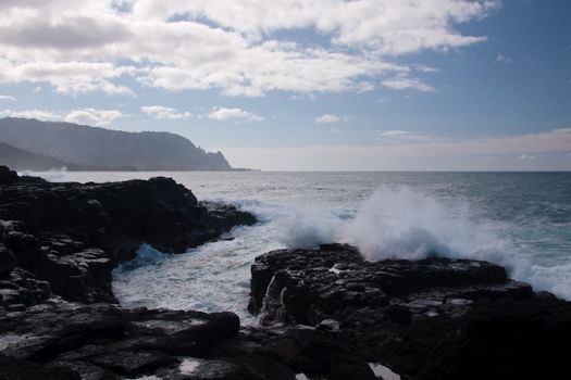 Waves breaking on the rocky lava coastline of north Kauai