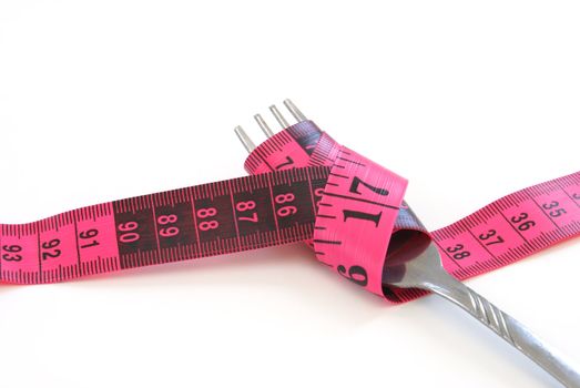A dieting concept with a fork and a measuring tape.