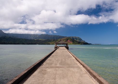 View down the pier at Hanalei in Kauai towards the Na Pali coast