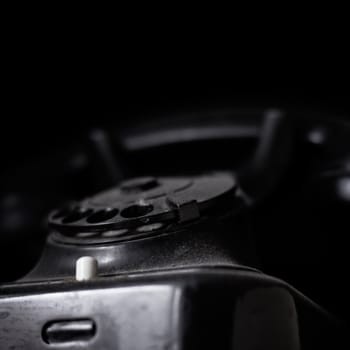 Vintage dusted phone on dark background, with copyspace.