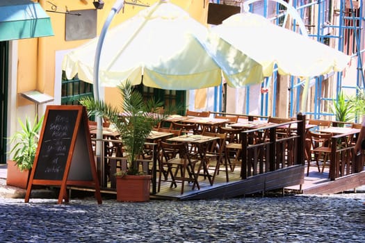 empty tables in street cafe
