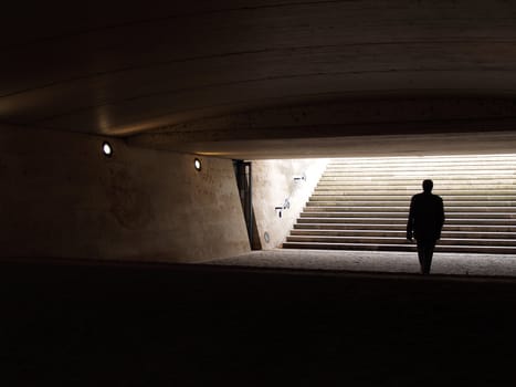 Man walking in the underpass.  