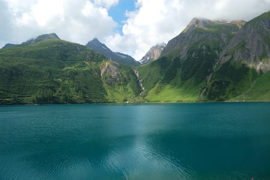 Panoramic view of an alpine lake (Morasco lake, Italy)