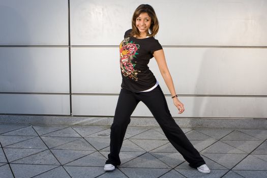 Young teenager grooving to hip hop music on the dance floor