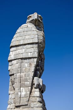 A statue of an eagle with a blue sky background