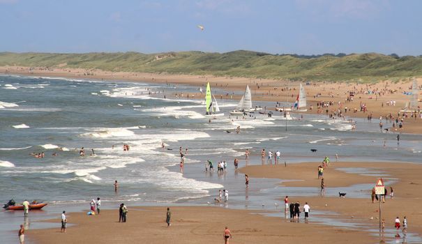 Coast of Holland, with swimmers and sailboats