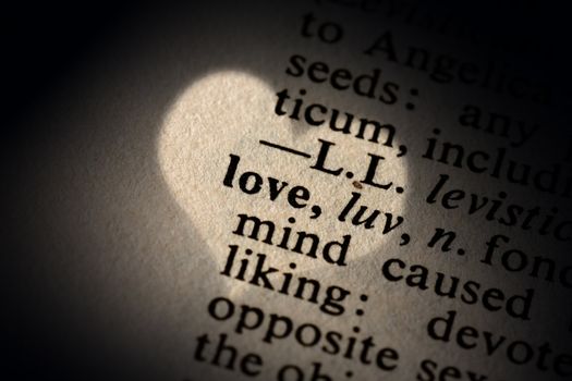 Closeup of the word love with a spot light on the text