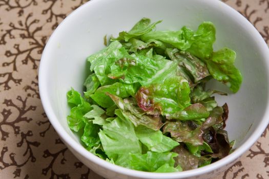 Fresh bowl of green salad with creamy white french dressing