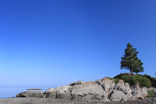 landscape including rock, river and blue sky