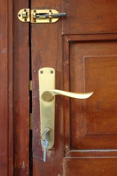 brown wood door and metal key ring