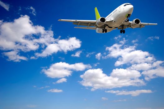 Air plane is flying. With blue and cloudy sky.