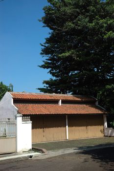 garage with two doors and green tree