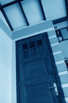 a wooden door in stone and brick wall