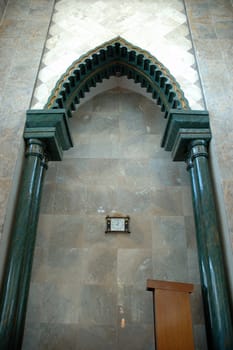 masjid hall with white marble wall and chandler