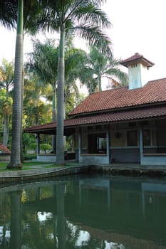 farm house with small fish pond in front of it