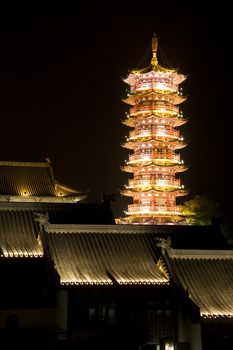 Night image of the Mulong Lake pagoda and buildings at Guilin, China.