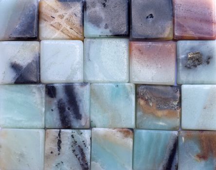 Background of blue and pink square agate gemstones