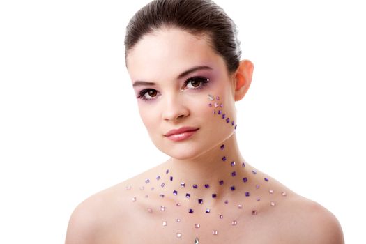 Headshot of a beautiful Caucasian woman with purple makeup and rhinestones, isolated