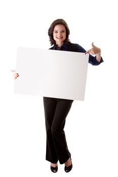 Happy smiling beautiful young caucasian brunette business student woman standing holding a white blank board and pointing at it, isolated