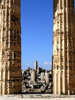 Temple columns with ruins in the background