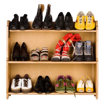 Shoes,  gym shoes, boots and other footwear stand on a rack
