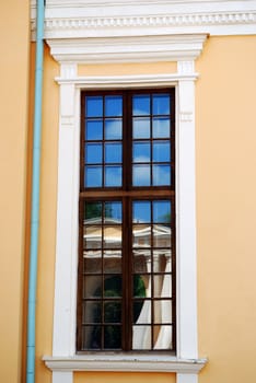 Window of historical building with another building reflected