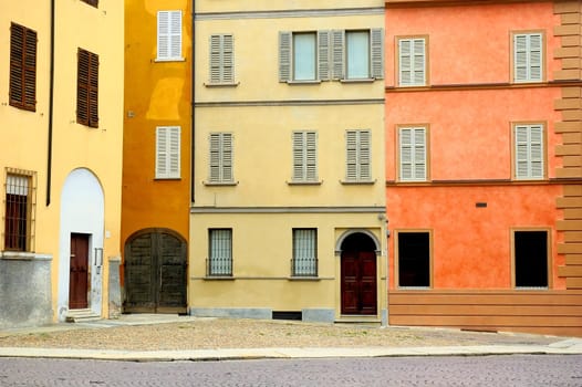 Colored Italian houses overlooking little square with cobblestones