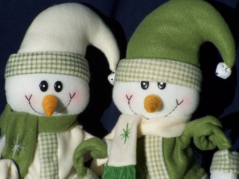 close-up of two smiling snowmen ready for winter