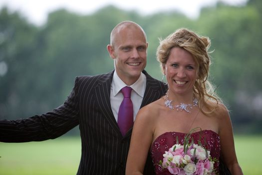 Pretty bride and groom outdoors posing