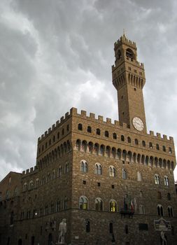 Clouds gather over the Palazzo Vecchio in Florence, Italy. The palace is now the Town Hall of Florence and contains two small jail cells that imprisoned Cosimo de' Medici (the Elder) and reformation leader Girolamo Savonarola in the 1400's.