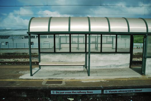 A platform roof at the station with warning signs