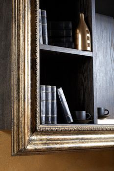 Magnificent shelf with books, cups and a bottle