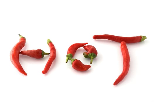 Chili peppers forming the word hot isolated on white