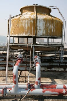 Old water tank on the roof of a Macao hotel. Still in use, despite the condition. 