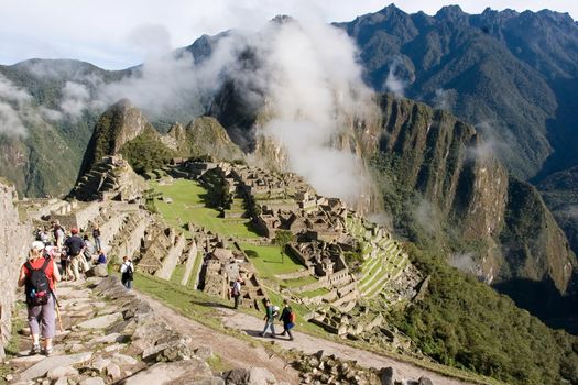 Machu Picchu (Quechua: Machu Picchu, "Old Peak") is a pre-Columbian Inca site located 2,400 meters (7,875 ft) above sea level[1]. It is situated on a mountain ridge above the Urubamba Valley in Peru, which is 80 km (50 mi) northwest of Cusco.