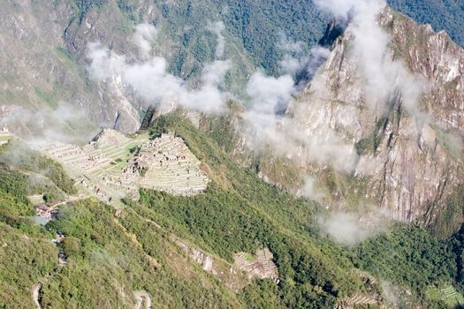 Machu Picchu (Quechua: Machu Picchu, "Old Peak") is a pre-Columbian Inca site located 2,400 meters (7,875 ft) above sea level[1]. It is situated on a mountain ridge above the Urubamba Valley in Peru, which is 80 km (50 mi) northwest of Cusco.