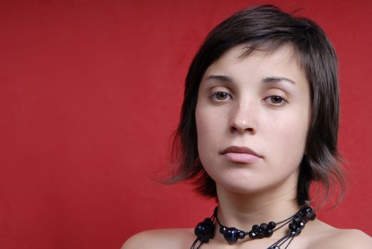 young woman portrait on red background