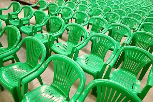 Many the green chairs placed by rows
