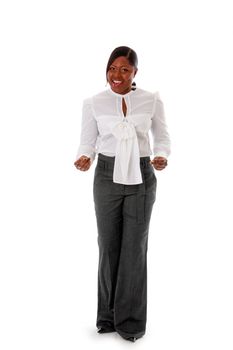 Beautiful African American business woman dressed in a white shirt and gray pants standing, snapping fingers, isolated