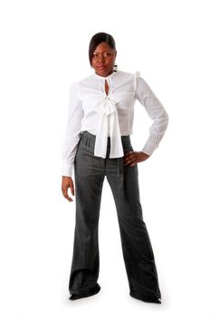 Beautiful African American business woman with tough attitude dressed in a white shirt and gray pants standing, isolated