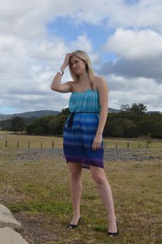 Attractive blond lady outdoors in her cocktail dress