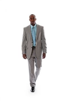 Handsome African American man in gray suit with smile walking, isolated