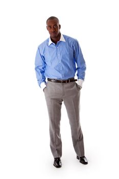 Handsome African American business man standing tilted with hands in pocket, wearing blue pinstripe shirt and gray pants, isolated