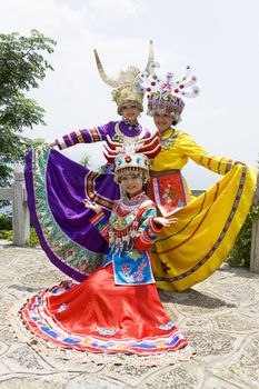 Image of young Chinese girls in traditional ethnic dress at Yao Mountain, Guilin, China.