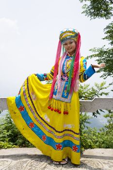 Image of a young Chinese girl in traditional ethnic dress at Yao Mountain, Guilin, China.