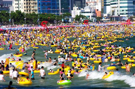 People enjoying swimming at Haeundae Beach, Busan, South Korea. At the height of summer more than a million people are estimated to visit Haeundae during the weekend. Photo taken on August 15th 2009.