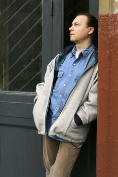 Thoughtful the man in a doorway