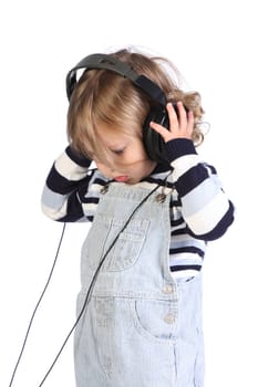 beauty a little girl listening music on white background